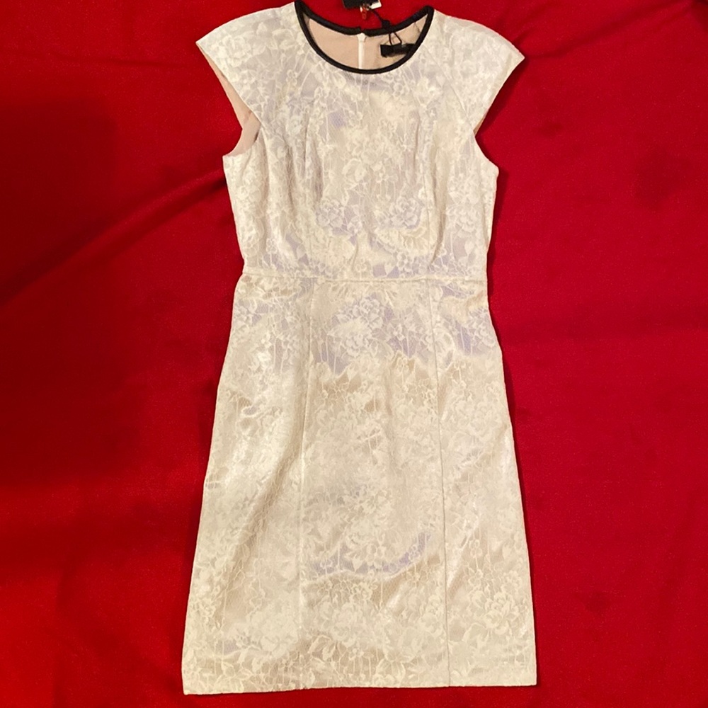 Dress, lined cream lace with brown faux leather trim at neckline. Never worn.